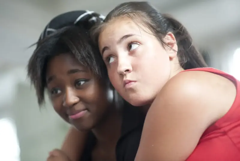 Young women with arms around each other
