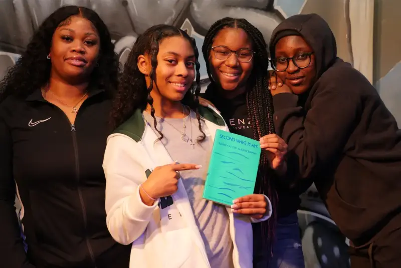 Young Women holding a book at Second Wave